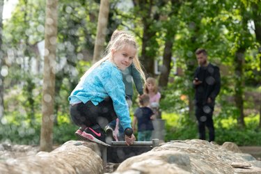 A child plays in the Water Play area at Standalone Farm