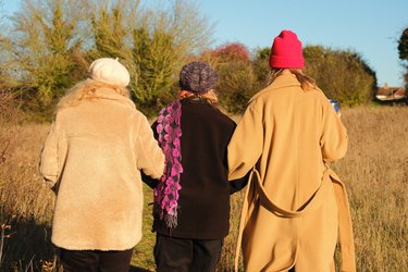 Three people walk through Letchworth fields in Winter.