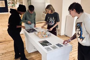 Four young people work together in Broadway Gallery at The Future of Garden Cities Exhibition