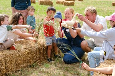 The Living Theatre group run an outdoor puppets workshop with children and their parents.