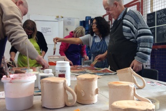 Group making and decorating clay items in Letchworth