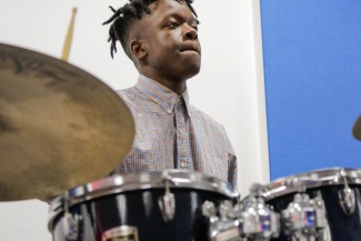 Morgan Simpson, a grant recipient, plays the drums