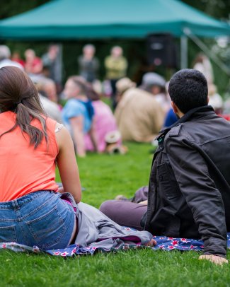 People sitting in the park enjoying a party